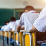 Survei: Mayoritas Guru Setuju Penghapusan Ujian Nasional dan Keberlanjutan PPDB Zonasi Rear view of middle school students studying in classroom